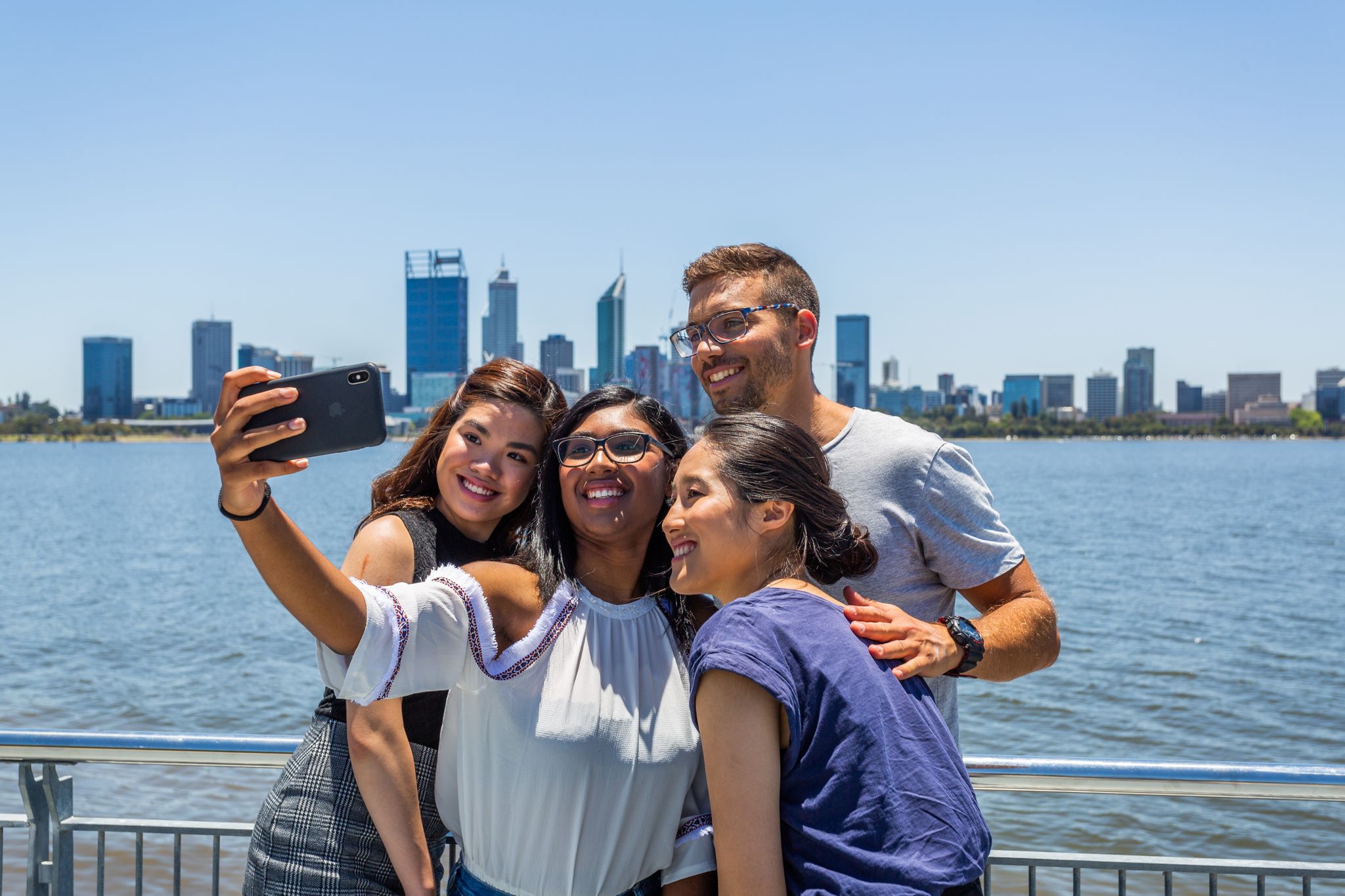 Group of students in front of Swan River and Perth city skyline, Western Australia